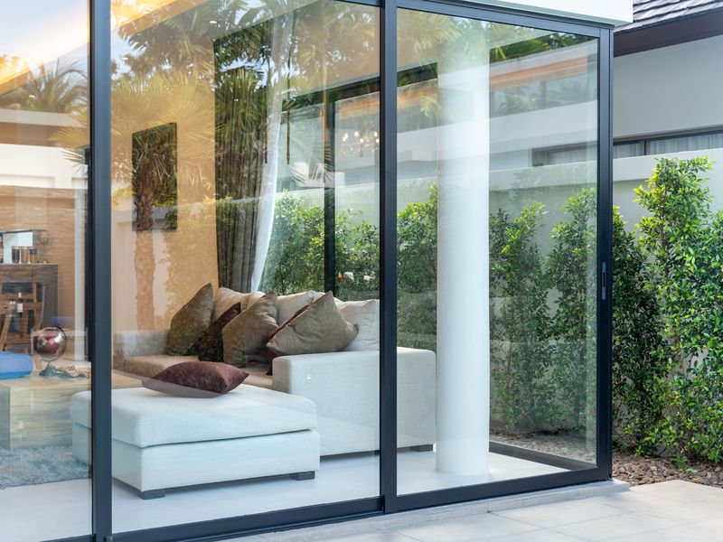 Large aluminum framed sliding glass doors on a modern home