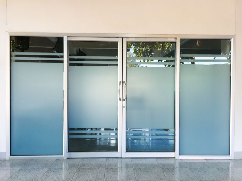 Frosted glass commercial double doors in an aluminum frame