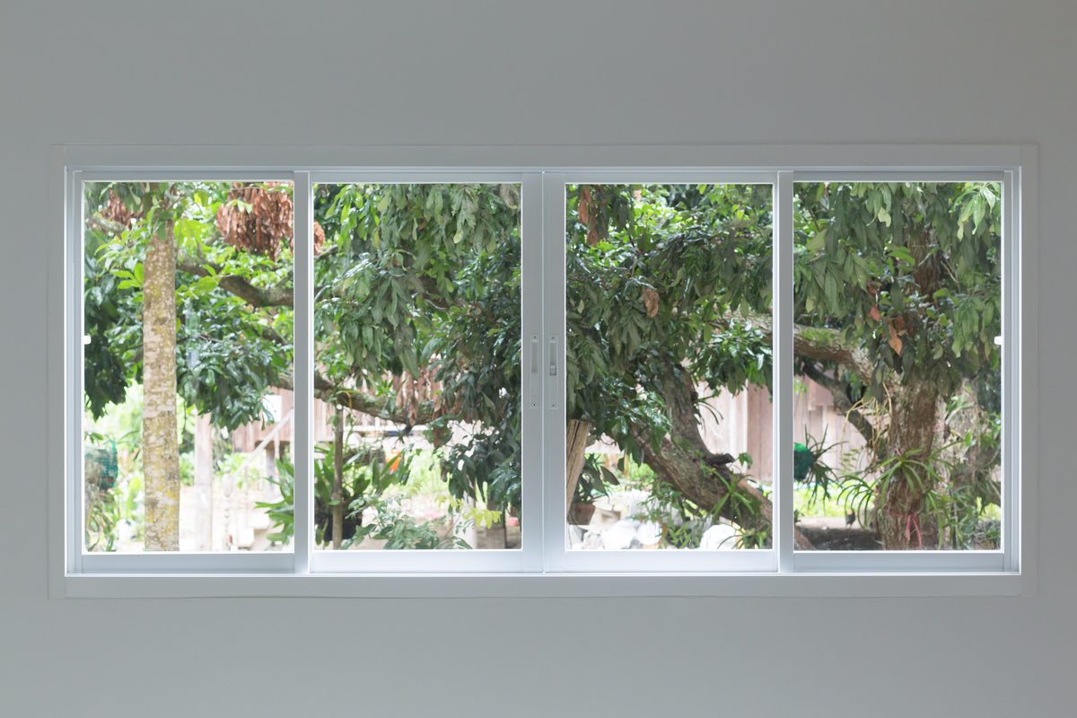 Four panel sliding window unit installed in a home interior